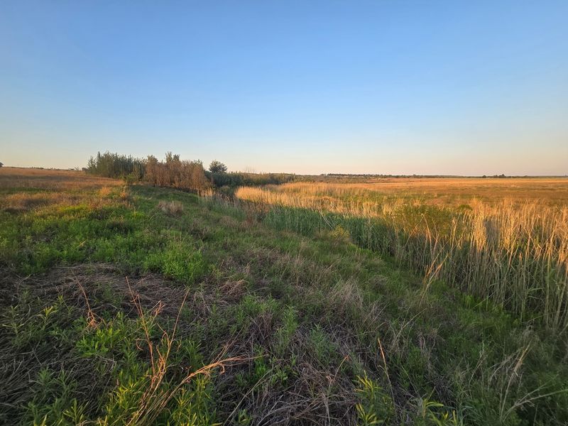 A scenic view of the expansive natural landscape and open fields on the farm property.