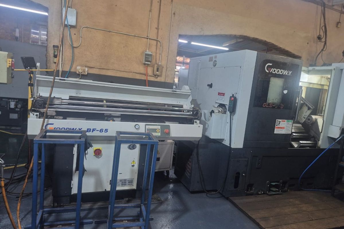 Industrial utility space featuring heavy-duty Goodway machinery, exposed electrical infrastructure, and durable epoxy flooring suitable for commercial manufacturing operations.