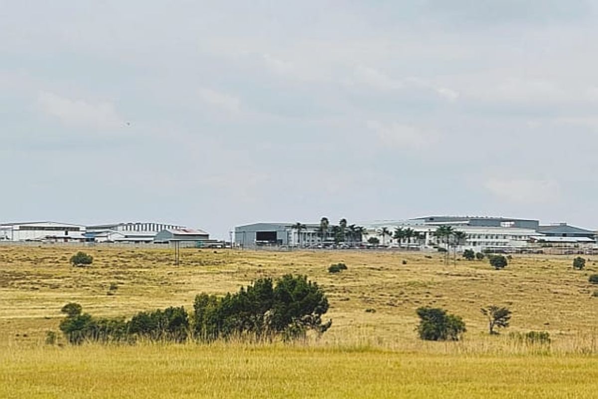 A wide-angle aerial view of a commercial industrial park featuring multiple warehouse buildings set within a large open landscape.