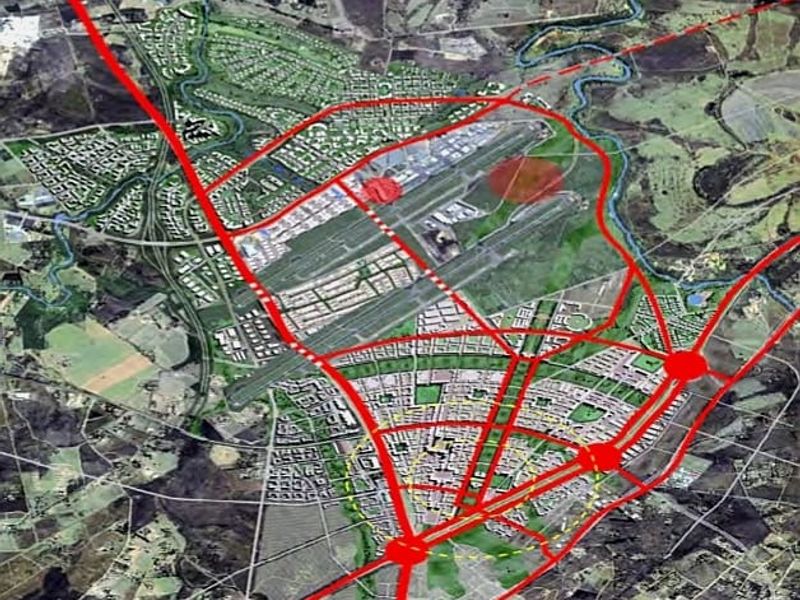 An aerial conceptual master plan showing proposed road networks and urban development zones for the commercial property area.