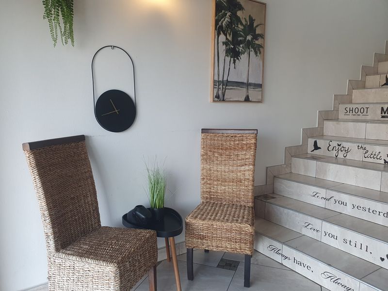 An inviting entryway featuring a tiled staircase with decorative risers and neutral floor tiling.