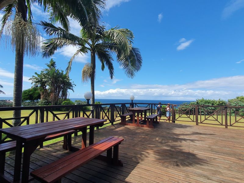 Spacious outdoor timber deck featuring a balustrade and ocean views, providing an ideal area for relaxation or commercial outdoor seating.