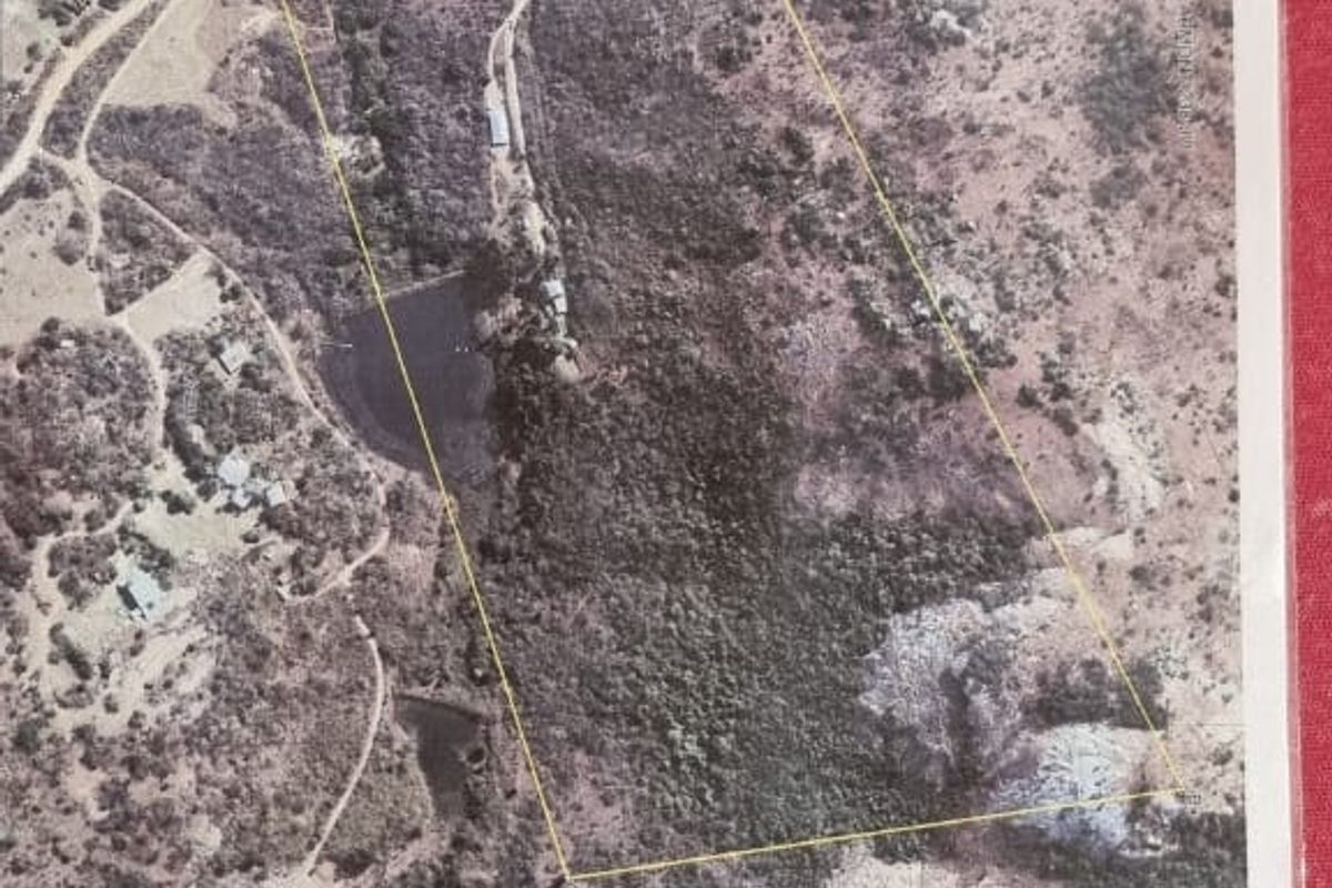 An aerial view of the farm property showing the land boundaries, access roads, and a water reservoir on the site.