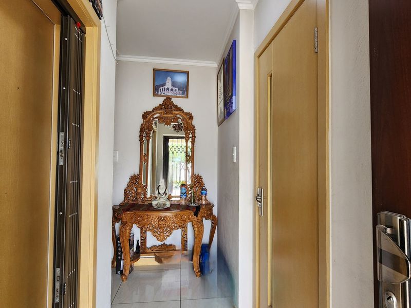 A well-maintained interior hallway featuring tiled flooring, neutral walls, and multiple internal door access points.