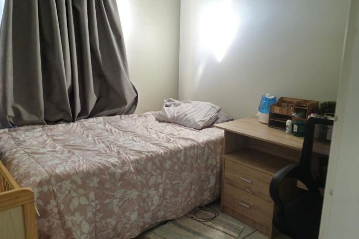 A compact bedroom featuring neutral wall finishes and standard flooring, suitable for a single bed and study area.