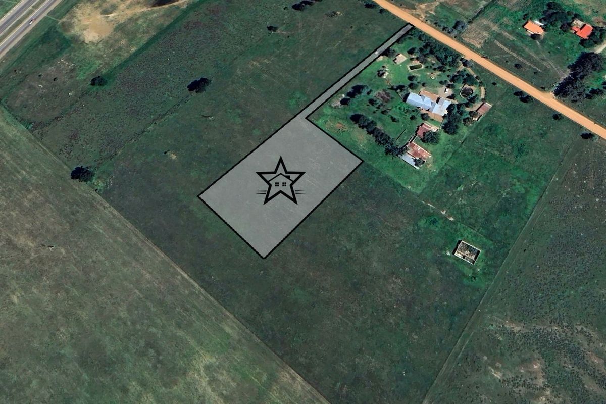 An aerial view of a vacant residential land plot marked with a star icon, showing surrounding rural landscape and access roads.