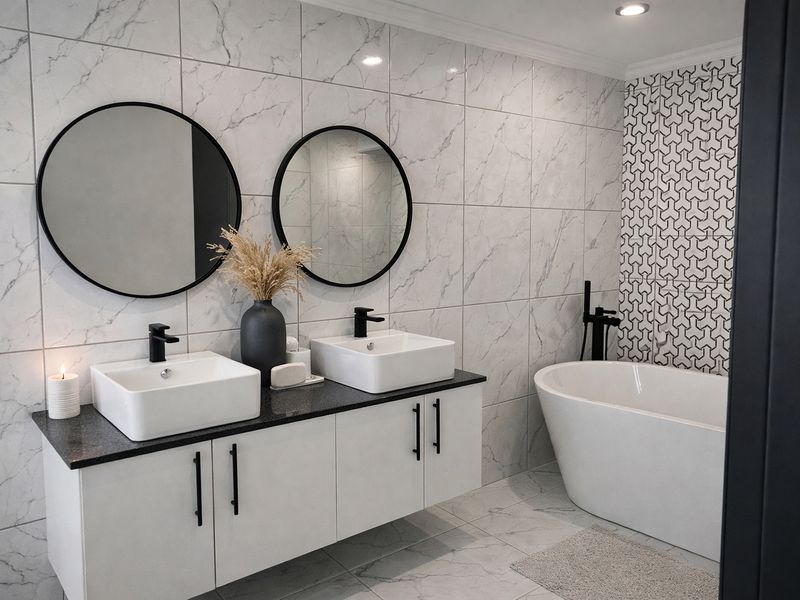 Modern bathroom featuring a double vanity with vessel sinks, a sleek freestanding bathtub, and contemporary marble-look wall tiling with a geometric feature wall.