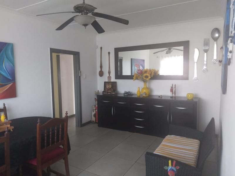Dining room featuring tiled flooring and a ceiling fan, providing a functional space for meals.