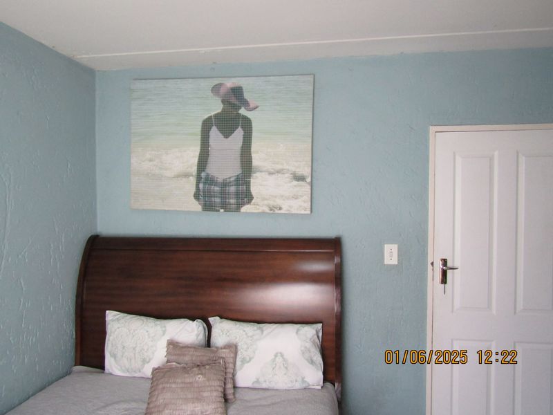 A bedroom featuring blue textured walls and a standard interior door.