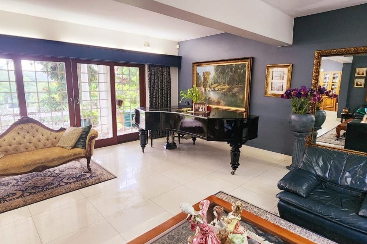 Spacious living room featuring polished porcelain flooring, large sliding glass doors providing natural light, and a modern bulkhead ceiling design.