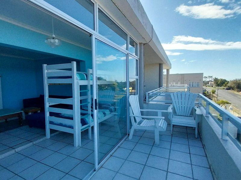 A spacious balcony with tiled flooring and metal balustrades, offering an outdoor extension to the adjacent interior living space.
