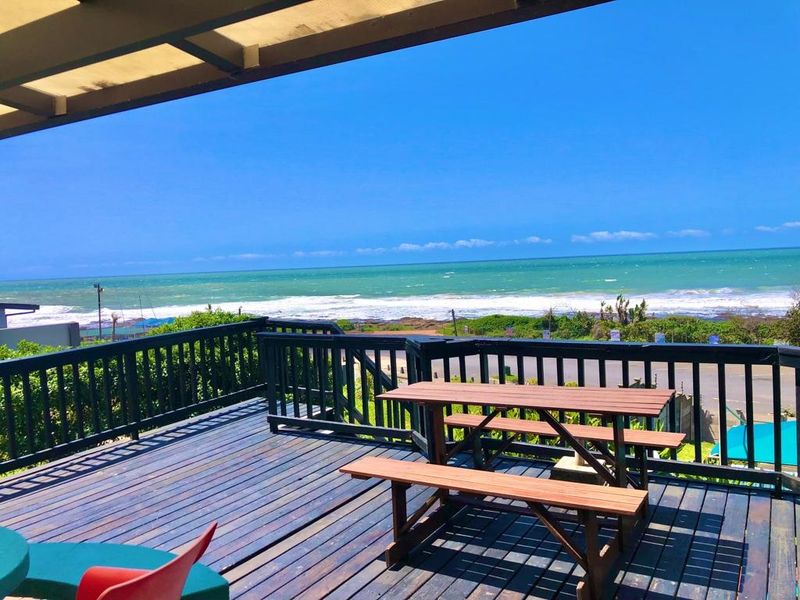 Spacious elevated timber deck featuring a covered area and panoramic ocean views, perfect for outdoor entertaining.