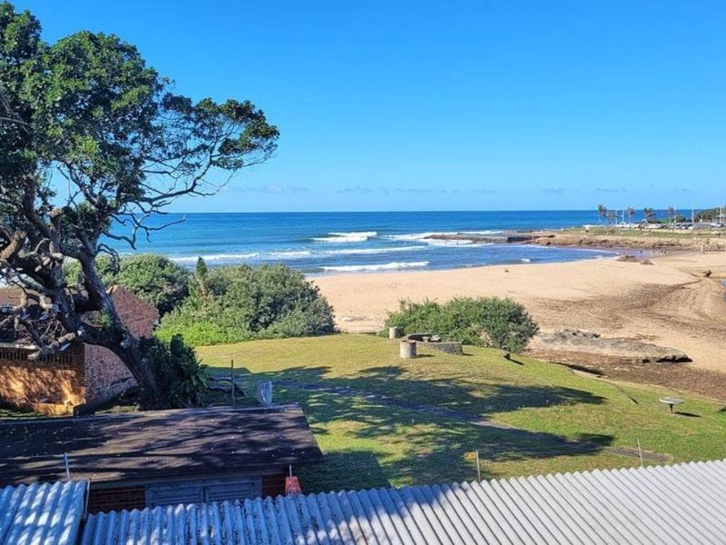 Elevated coastal view overlooking the beach, ocean, and surrounding natural landscape.