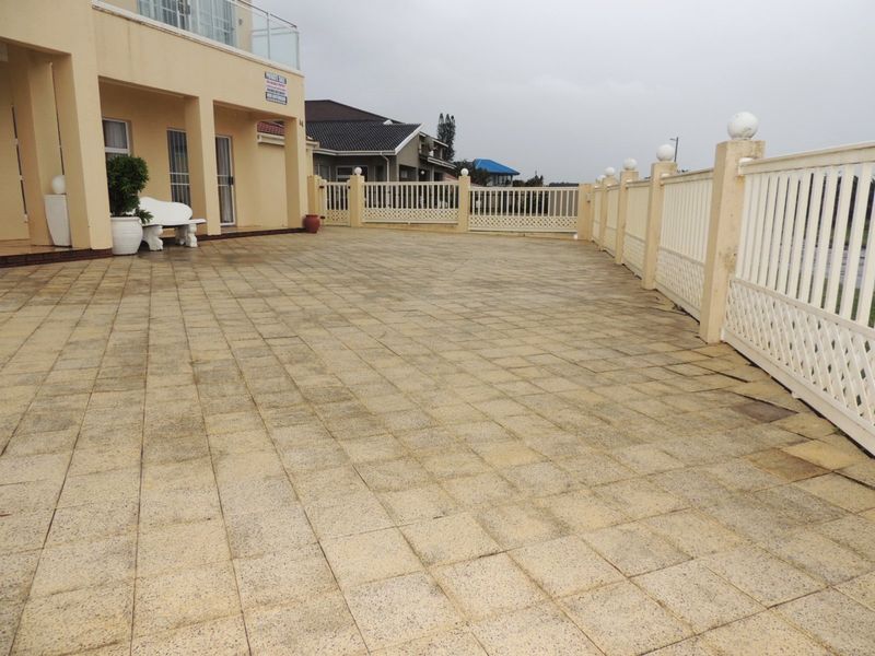 Spacious paved patio area featuring perimeter fencing and direct access to the main dwelling, suitable for outdoor entertainment.