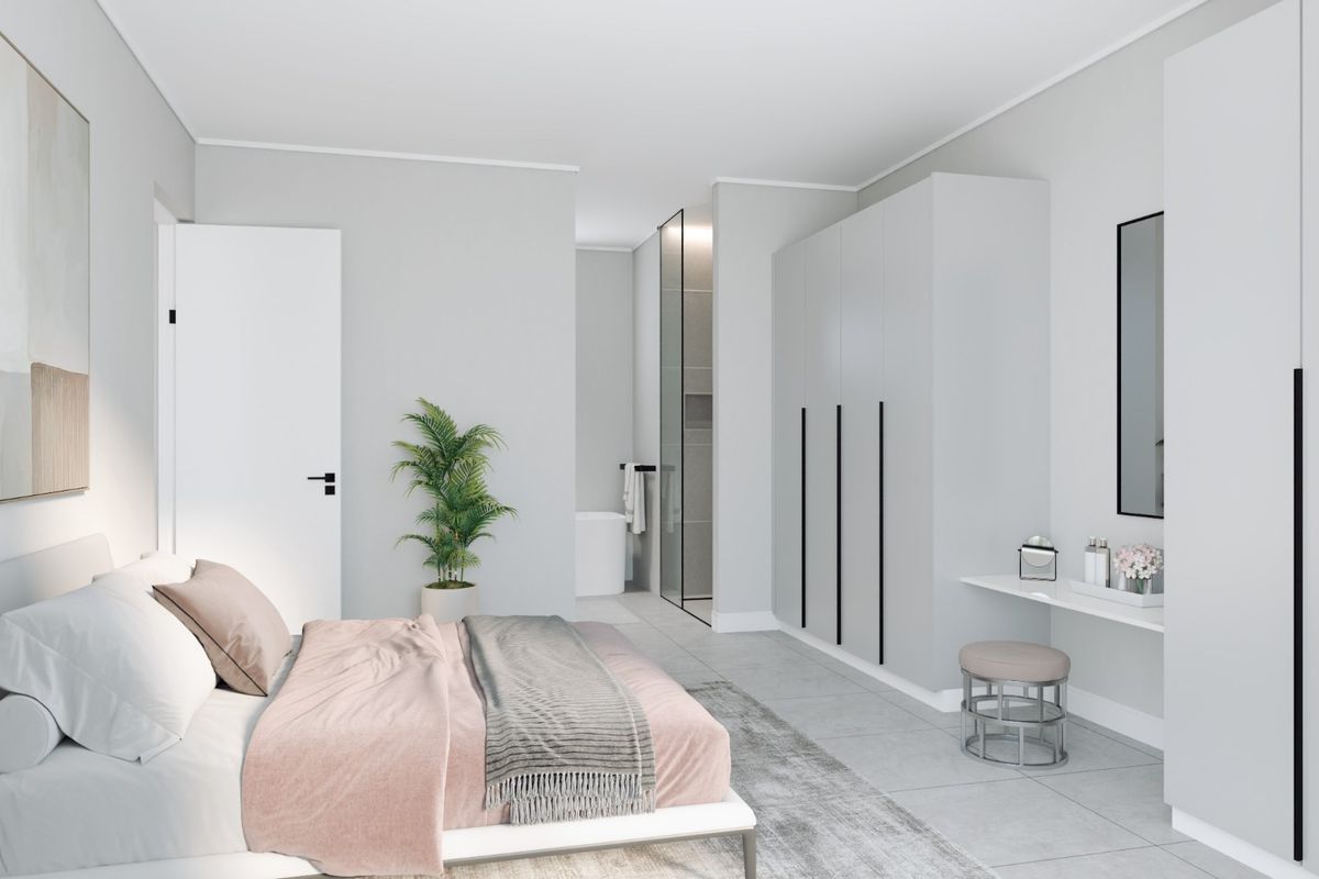 Modern bedroom featuring built-in wardrobes, a sleek integrated vanity, and direct access to an en-suite bathroom with contemporary finishes.