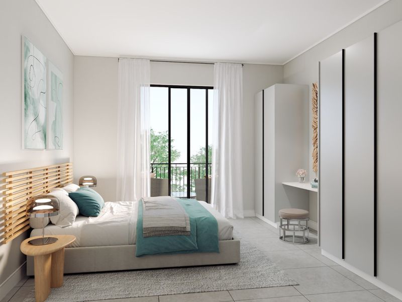 Modern bedroom featuring built-in wardrobes, tiled flooring, and a sliding glass door providing access to a private balcony.