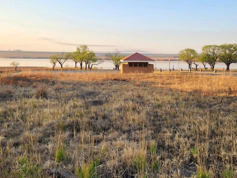 A scenic view of the vacant residential land overlooking the waterfront and surrounding natural landscape.