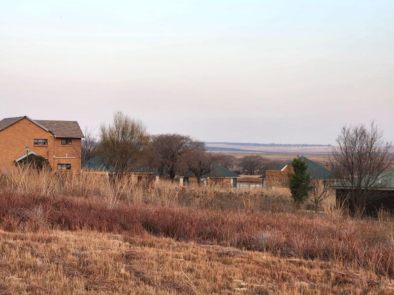 A scenic view overlooking a residential area with multiple houses set against a natural landscape.