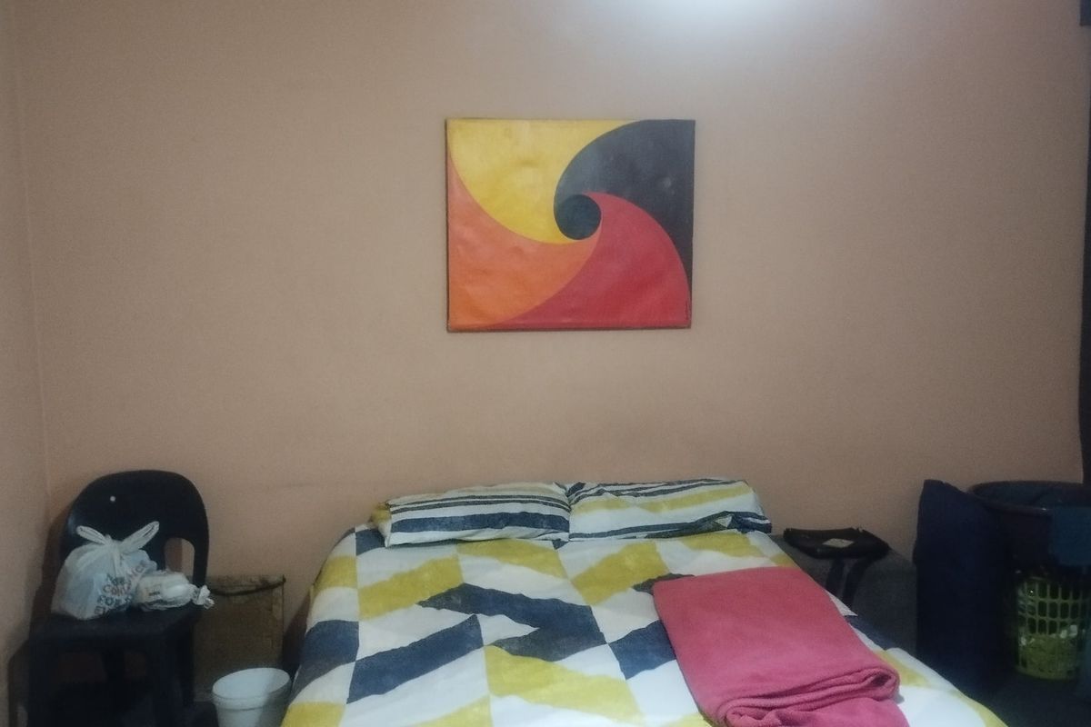 A bedroom featuring plain painted walls and standard interior finishes, suitable for renovation or restyling to enhance the space.