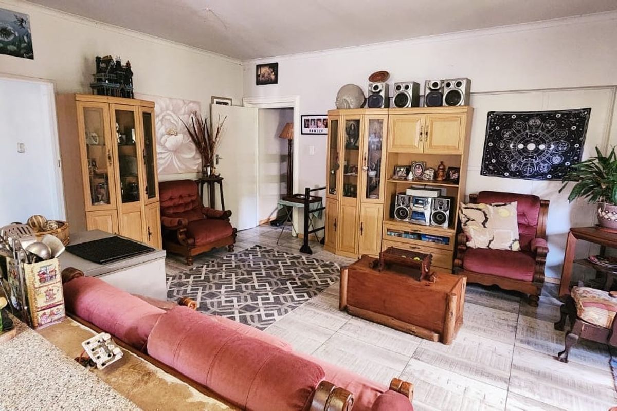 A spacious living area featuring tiled flooring and neutral wall finishes, offering a functional layout for comfortable family living.