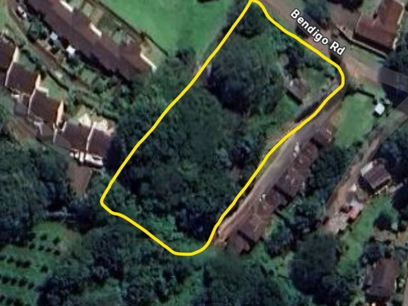 An aerial view of a vacant residential plot of land, heavily vegetated and situated along Bendigo Road.