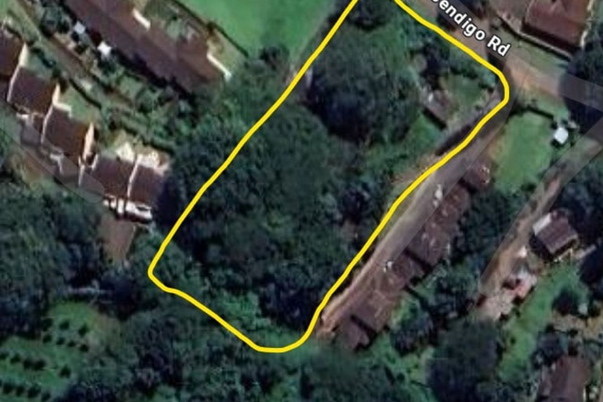 An aerial view of a vacant residential plot of land, heavily vegetated and situated along Bendigo Road.