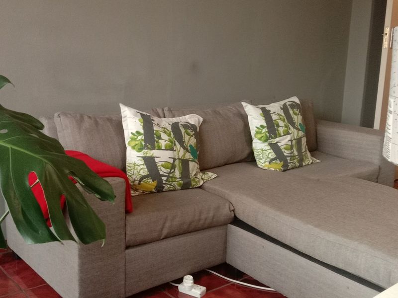 A living room area featuring tiled flooring and neutral wall finishes.