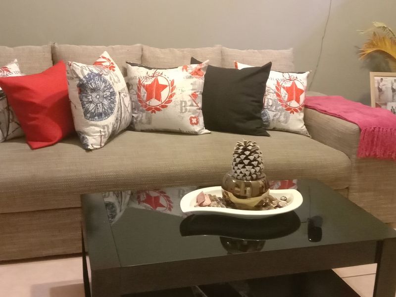 A living room area featuring neutral tiled flooring and a neutral wall finish, providing a functional base for interior styling.