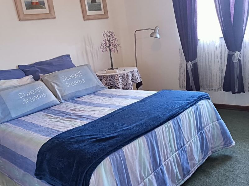 A standard bedroom featuring carpeted flooring and neutral wall finishes, providing a functional and comfortable sleeping space.