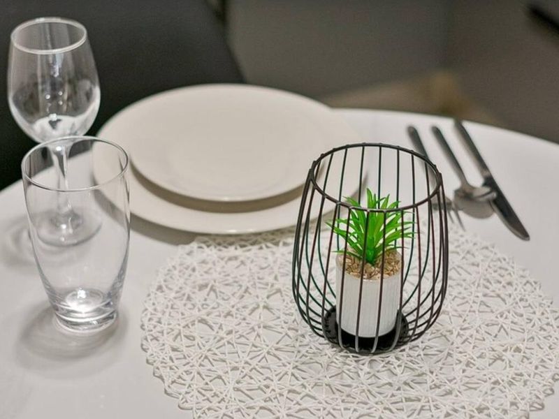 A close-up shot of a table setting with tableware and decorative items.