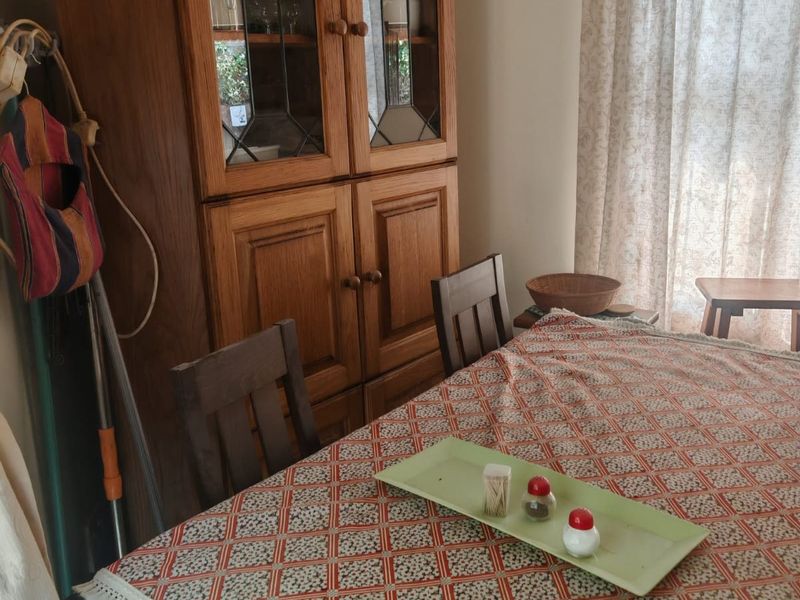 A dining area featuring a window with curtains, providing a functional space for meals.
