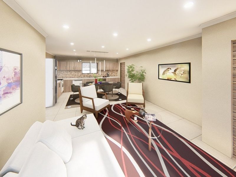 An open-plan living and kitchen area featuring tiled flooring, recessed lighting, and modern kitchen cabinetry with a tiled backsplash.