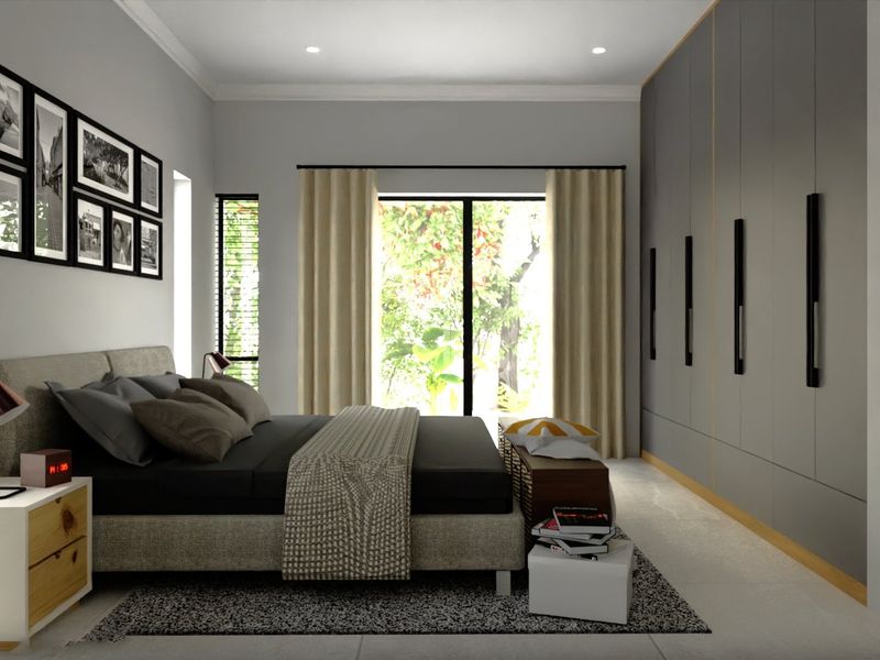 A modern bedroom featuring extensive floor-to-ceiling built-in cupboards, recessed lighting, and a sliding glass door providing natural light and garden views.