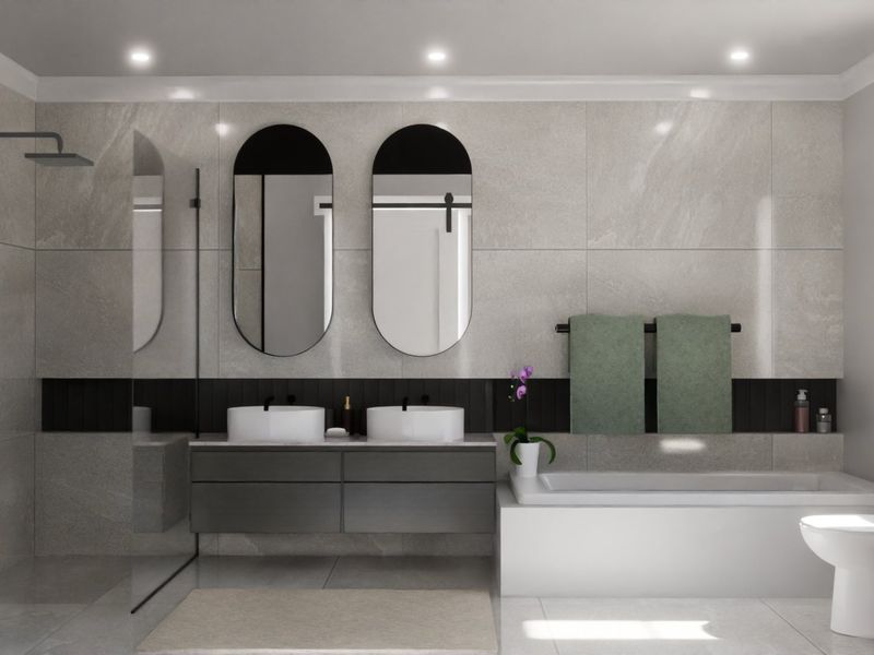 Modern, well-appointed bathroom featuring a double vanity, walk-in shower, built-in bathtub, and contemporary finishes throughout.
