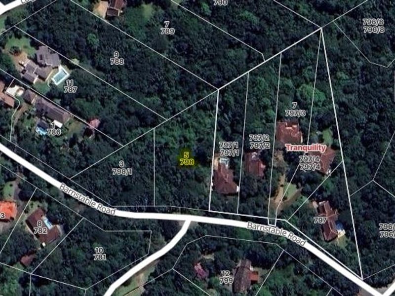 An aerial view showing the residential land parcel located on Barnstable Road, surrounded by established trees and neighboring properties.