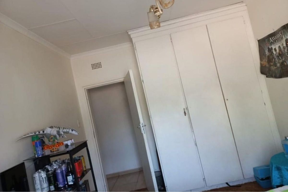 A bedroom featuring a built-in wardrobe and standard ceiling finishes.