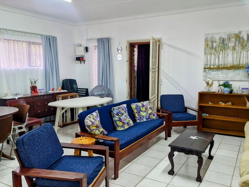 A spacious living area featuring tiled flooring and neutral walls, providing a versatile layout for comfortable family living.