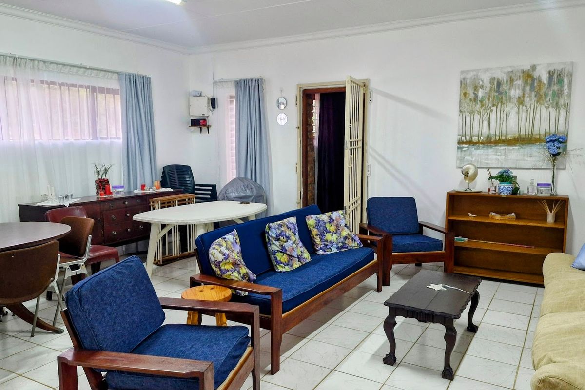 A spacious living area featuring tiled flooring and neutral walls, providing a versatile layout for comfortable family living.