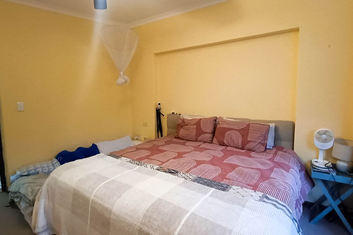A bedroom featuring a recessed wall niche and coving, providing a functional space with standard finishes.