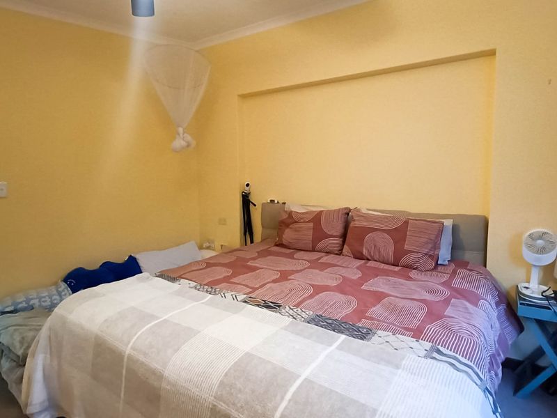 A bedroom featuring a recessed wall niche and coving, providing a functional space with standard finishes.
