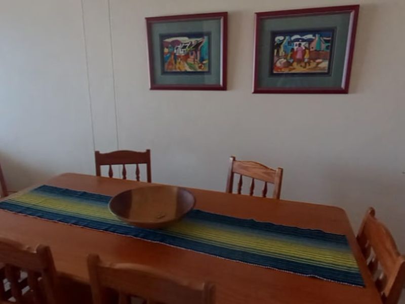 A dining room area featuring tiled flooring and neutral wall finishes, suitable for family meals and entertaining.