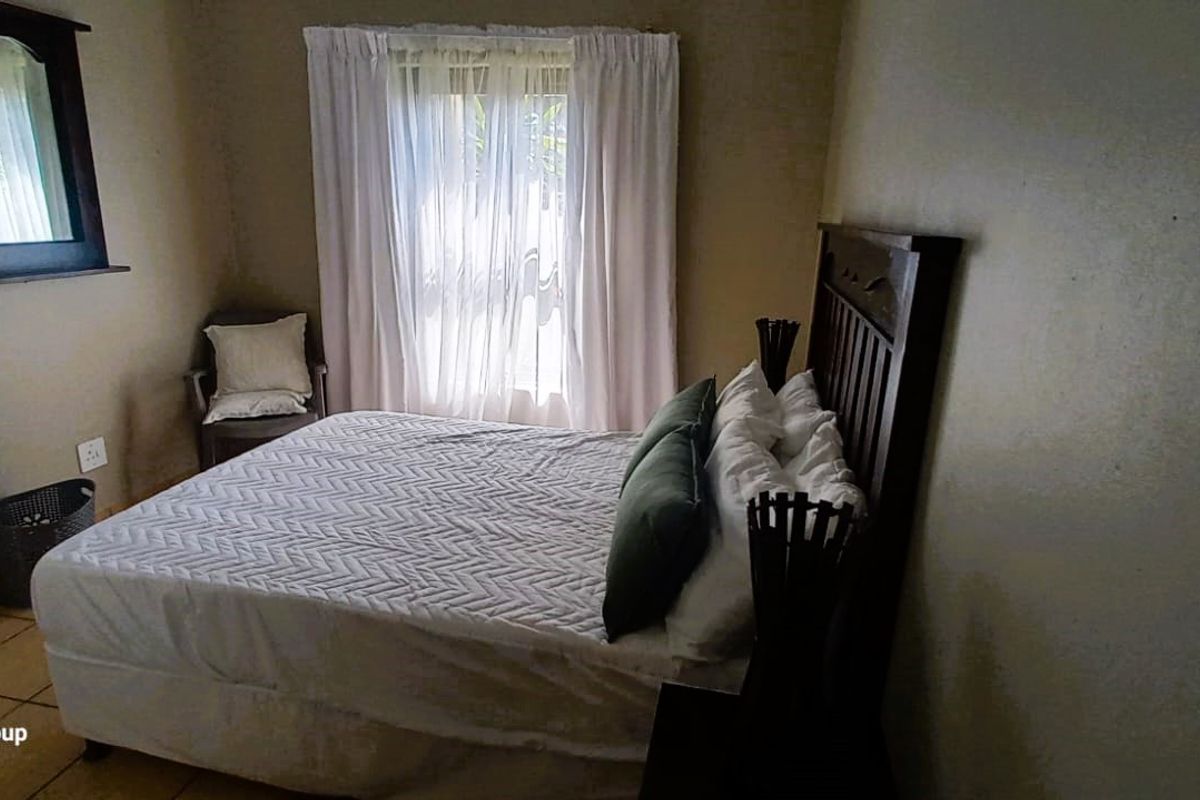 A standard bedroom featuring tiled flooring and neutral wall finishes, providing a functional and comfortable sleeping space.