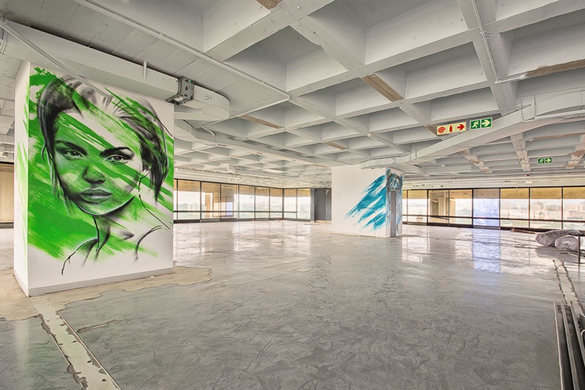 Expansive open-plan commercial office space featuring an exposed concrete waffle ceiling, large perimeter windows, and polished concrete flooring, ready for custom fit-out.