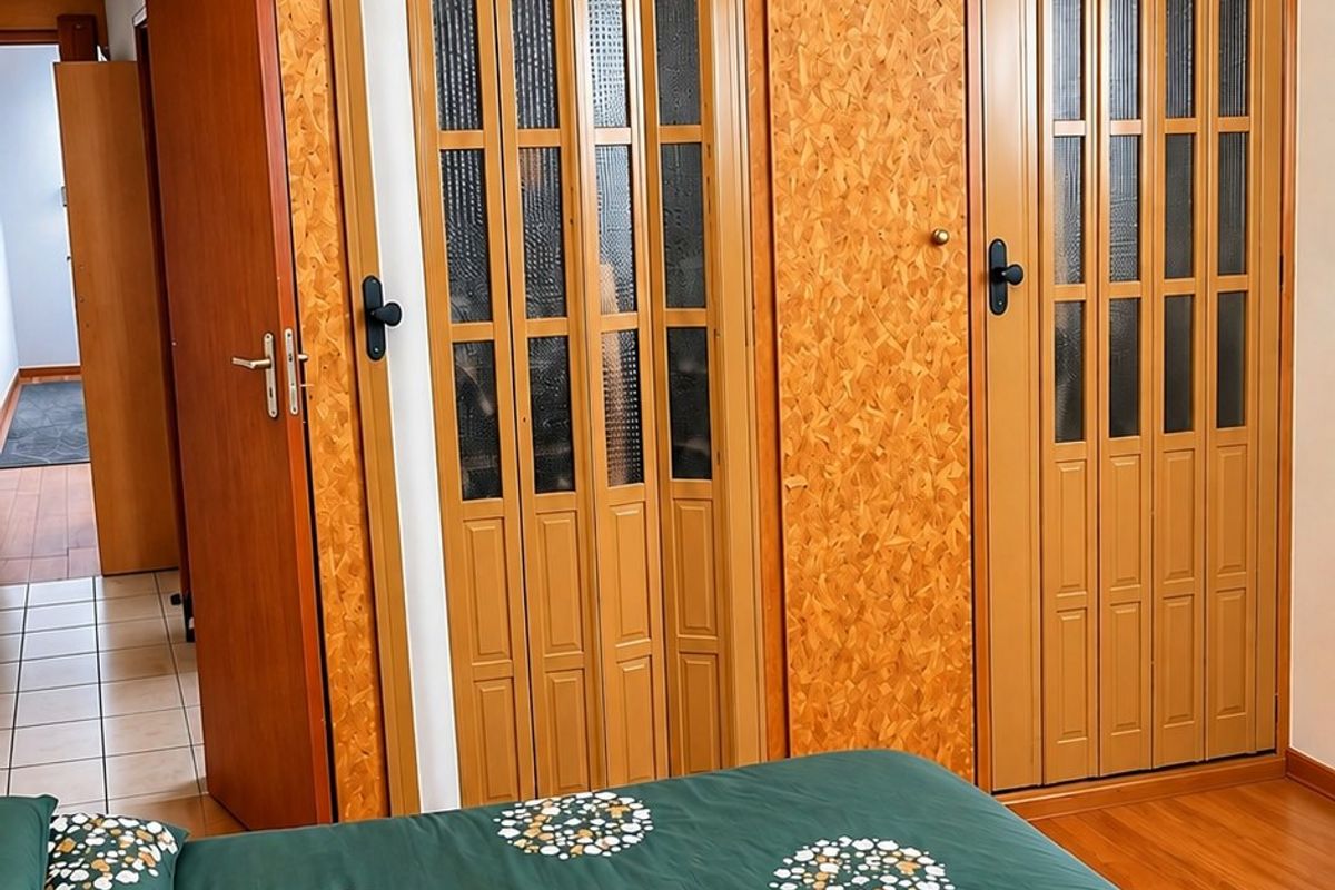 Bedroom featuring extensive built-in cabinetry with wood-look finish, a ceiling fan, and timber ceiling paneling.