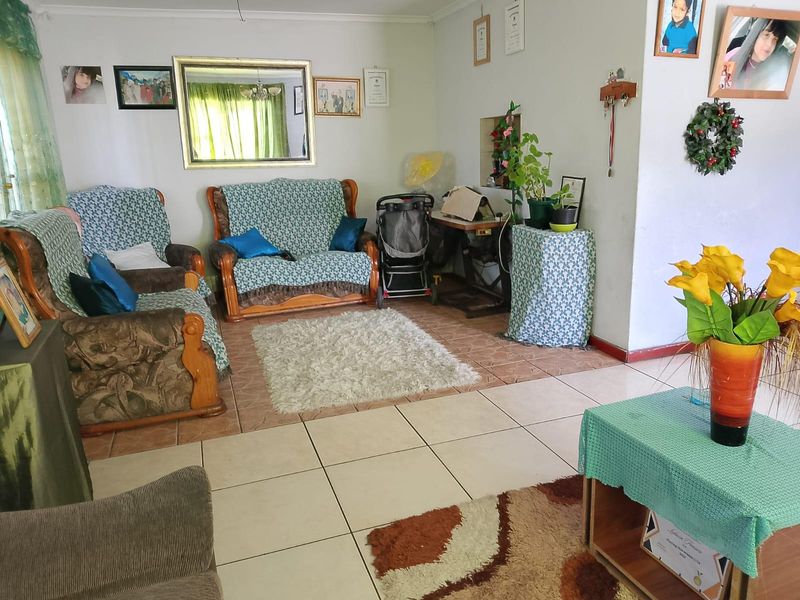 A living room area featuring tiled flooring and neutral wall finishes, providing a functional space for relaxation.