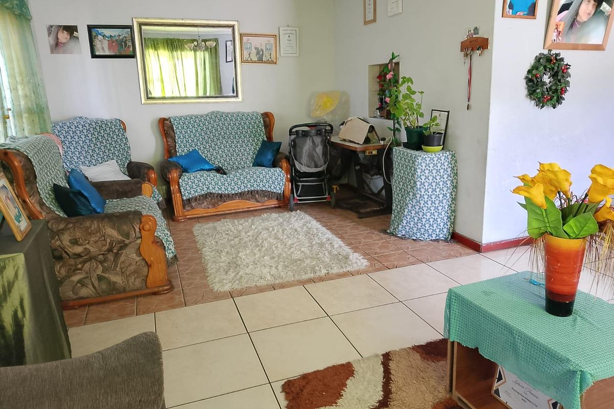 A living room area featuring tiled flooring and neutral wall finishes, providing a functional space for relaxation.