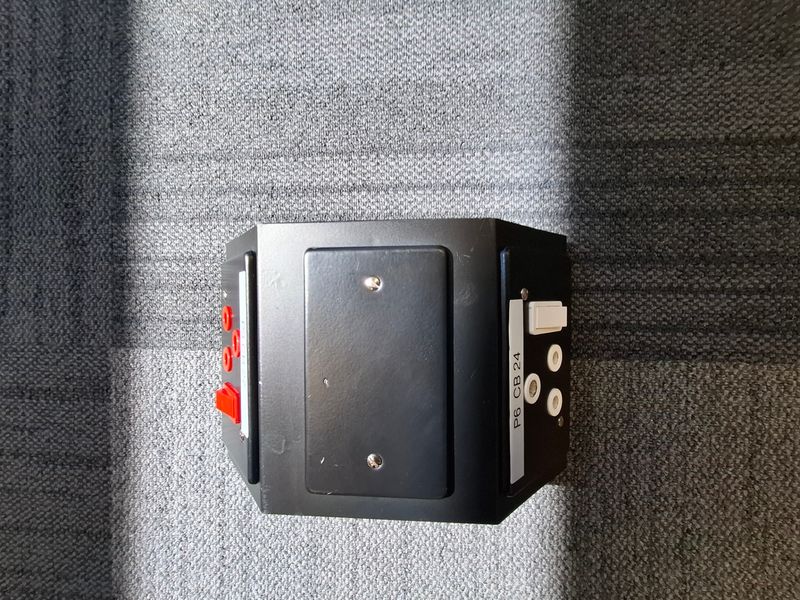 A close-up view of a wall-mounted electrical and data distribution unit featuring multiple power sockets and switches.