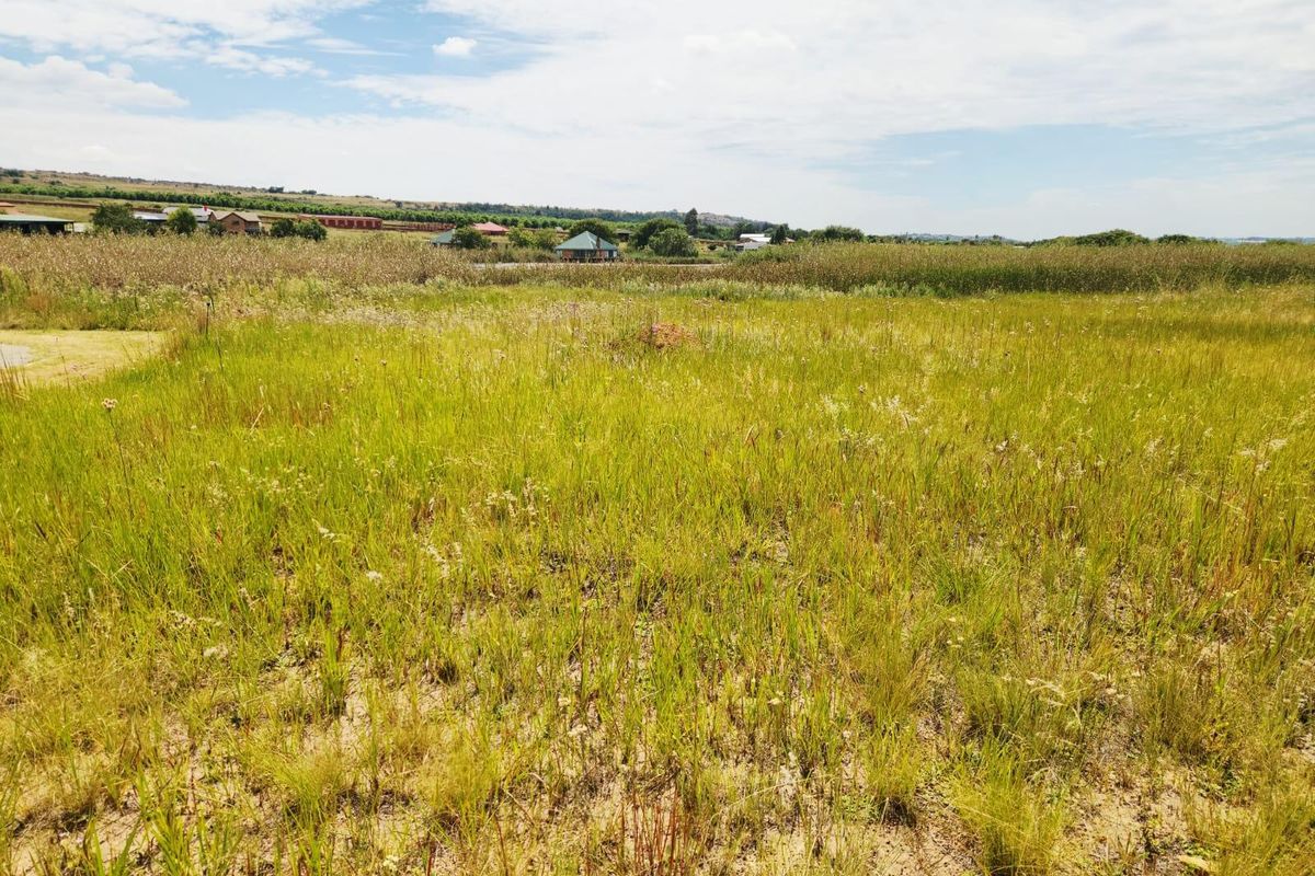 A view of the vacant residential land featuring natural grass coverage and surrounding landscape.