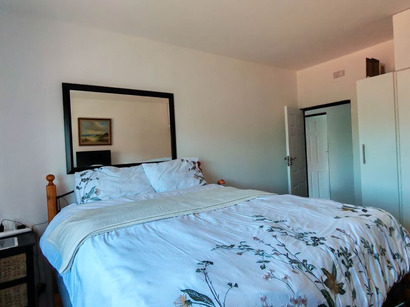 A functional bedroom featuring a built-in wardrobe and neutral wall finishes, providing a comfortable and practical living space.
