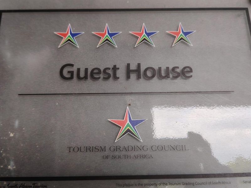 A four-star Tourism Grading Council of South Africa plaque displayed on the property.
